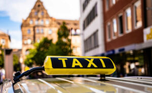 yellow-taxi-sign-old-historical-town-germany-closeup-cab-service-board-car-ancient-europ