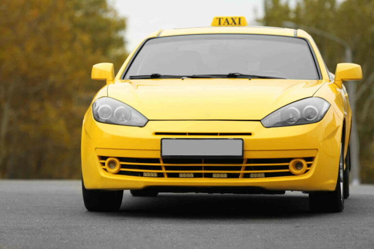 yellow-car-with-taxi-sign-roof-outdoor
